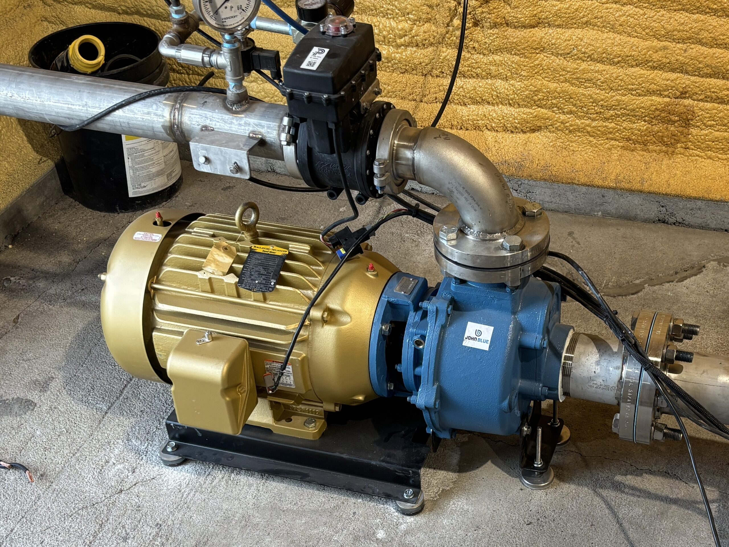 John Blue SP-3450-E20TB mounted stationary to concrete with stainless steel plumbing.